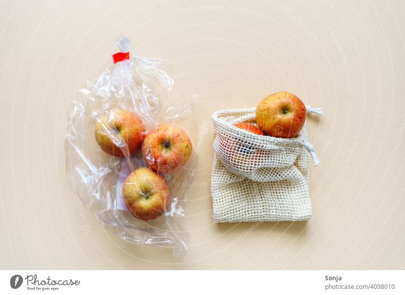 Red apples packed in plastic and in a reusable shopping net Apple Plastic bag String bag Reusable naturally fruit Organic produce Healthy Eating Environment