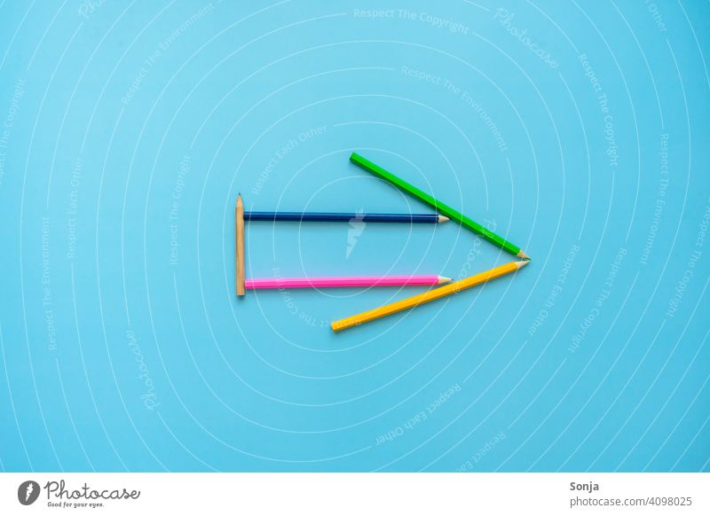 Arrow from crayons on a blue background Trend-setting Success Target Future Orientation Career Forwards Business Colour photo Sign Blue background plan