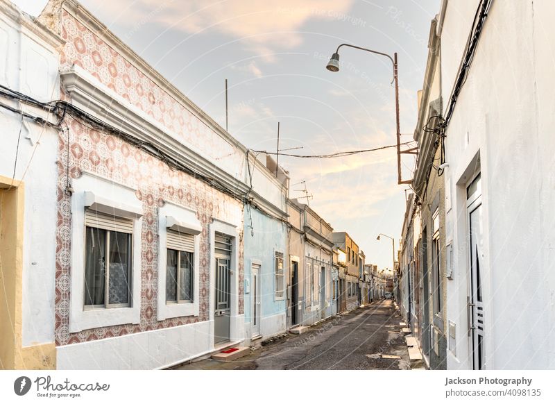 Small houses on the narrow street of historic Olhao, Algarve, Portugal olhao algarve portugal abandoned afternoon architecture blue building city cityscape