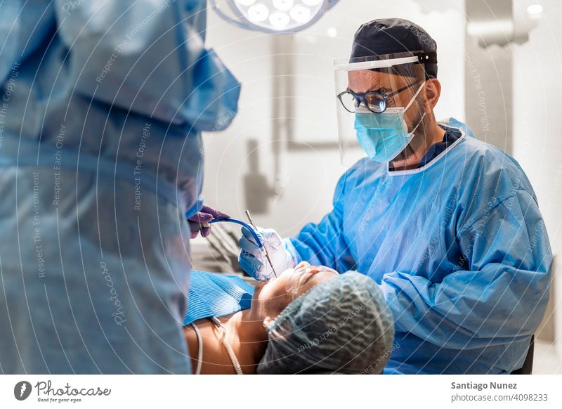 Dental Clinic Worker With Face Mask hair net plastic mask back view man patient sitting looking examining dentist clinic dental clinic lying health care