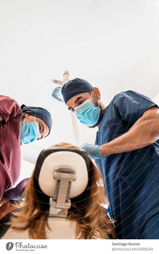 Dental Clinic Workers Bottom View man woman patient standing looking examining bottom view dentist clinic dental clinic lying health care equipment medicine