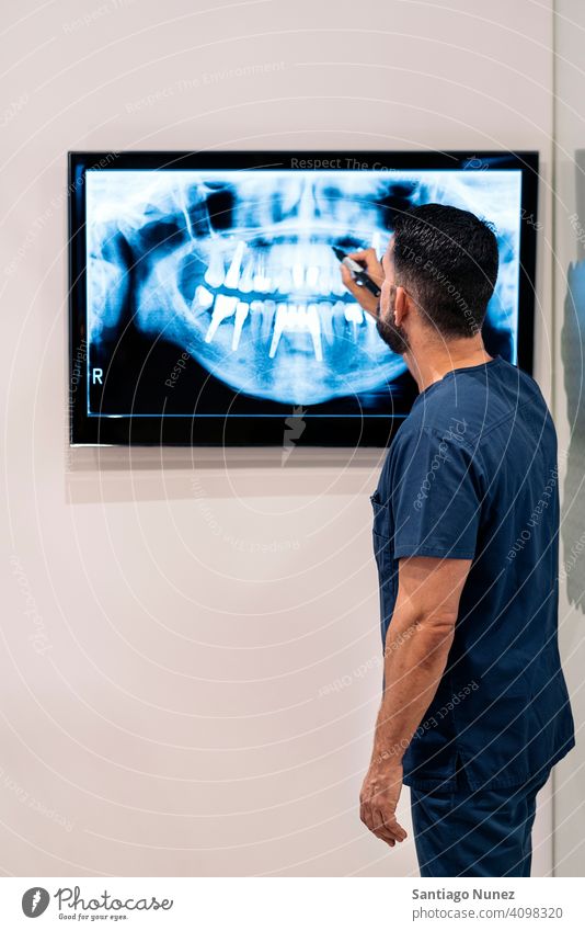 Dental Clinic Worker With X-ray man dental clinic showing medical doctor x-ray holding examining working care dentistry teeth patient hygiene equipment