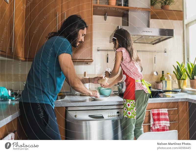 Happy family cooking in the kitchen. Father and child daughter cooking home people vitamin food copy space dairy young snack pleasure pretty father health