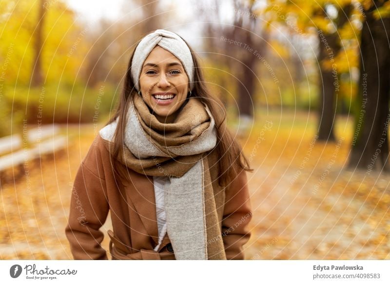 Portrait of smiling young woman in a park in autumn nature leaves freedom healthy trees yellow forest season public park relax serene tranquil fall outdoors