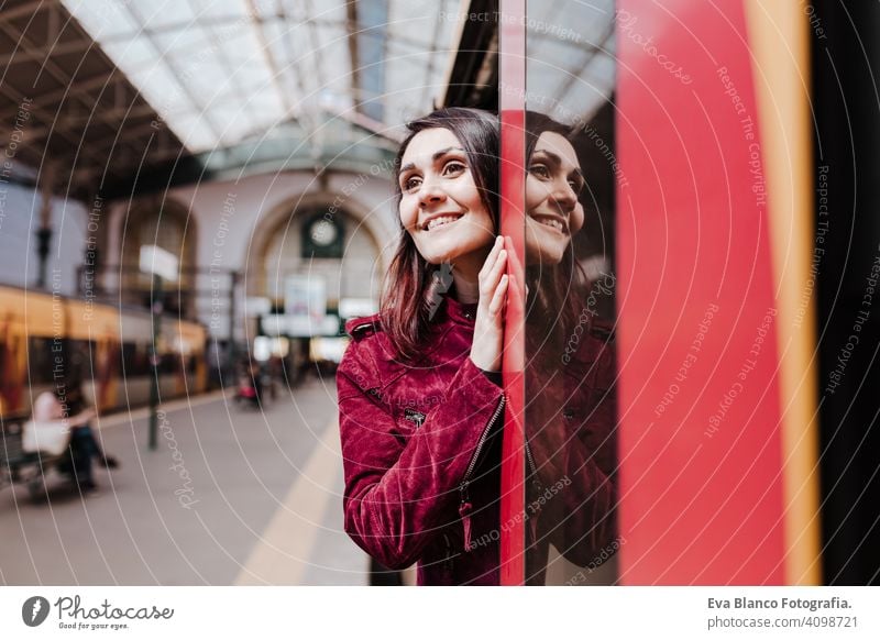 beautiful caucasian woman in train station ready to travel inside wagon. Travel and lifestyle concept city public transport boards young trip screen passenger