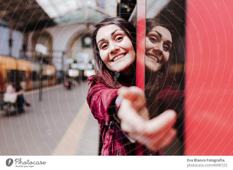 beautiful caucasian woman in train station ready to travel inside wagon. Travel and lifestyle concept city public transport boards young trip screen passenger