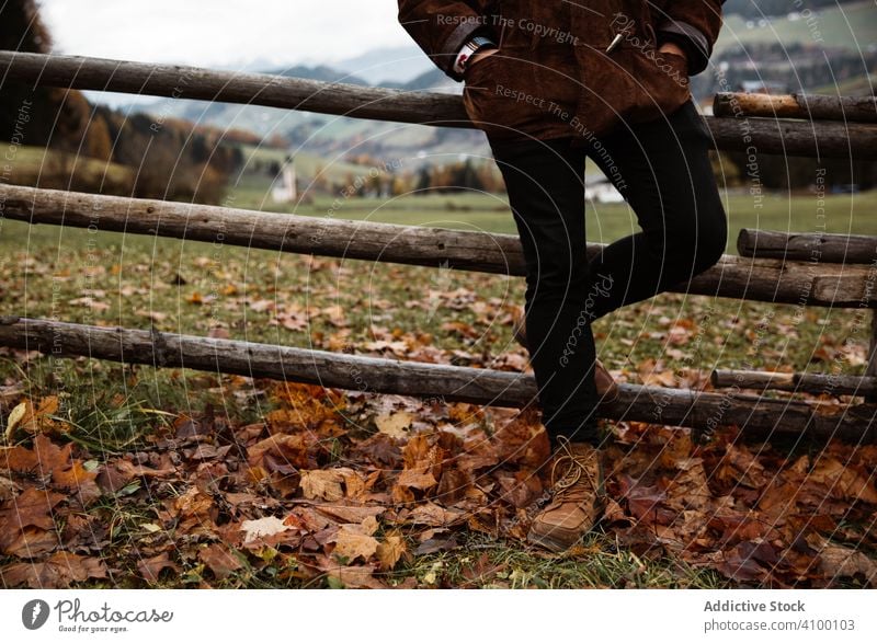 Man standing in beautiful mountains landscape man traveler fence peak cliff autumn outdoors rural lifestyle male horizontal countryside tourism landmark nature