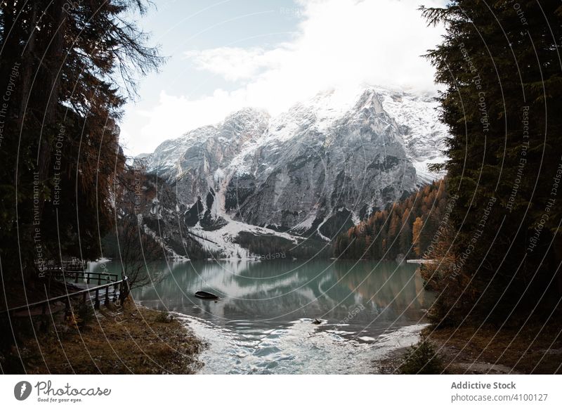 Beautiful lake and mountains pine tree forest sky wooden bridge nature rock landscape track vacation blue travel tourism destination sightseeing view dolomites