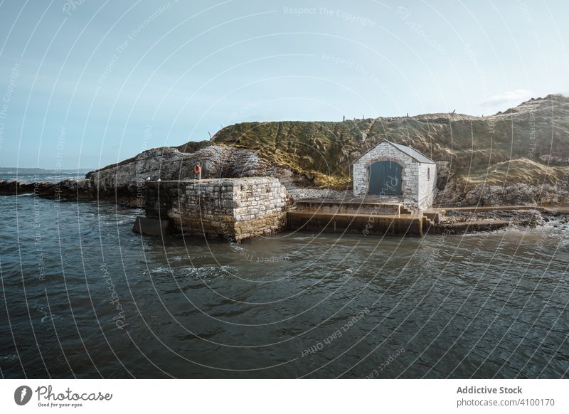 Aged building in quiet harbour rock landscape cliff sea shore coast water scenic nature old ancient aged ballintoy antrim northern ireland townland hill pier