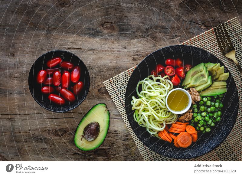 Zucchini raw vegan pasta with assorted vegetables. Vegan food zucchini vegetarian healthy detox lunch salad diet spaghetti cuisine organic green meal noodles