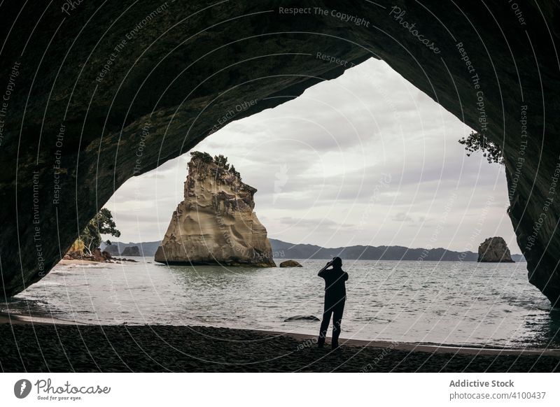 Traveler walking at tranquil sandy beach mountain rocks travel sea landscape nature coast water summer island tourism scenery vacation ocean trip coastline