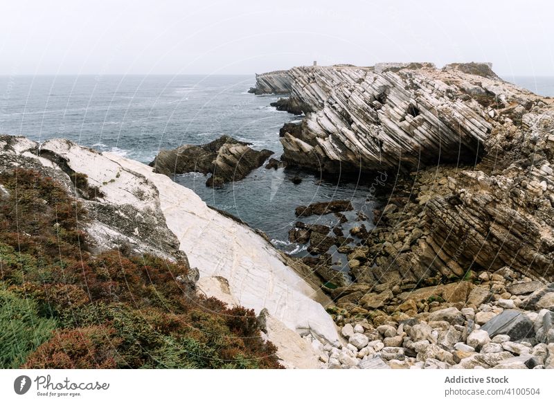 Rocky formations in the island of Baleal on the Atlantic coast in a foggy day. Peniche, Portugal peniche baleal baleal island surf tourism rocks rocky coastline