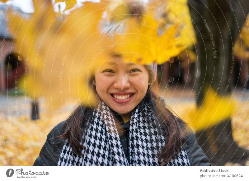 Happy ethnic female tourist enjoying autumn in Oslo woman throw maple leaf patio travel nature holiday relax rest vacation tourism oslo cathedral norway