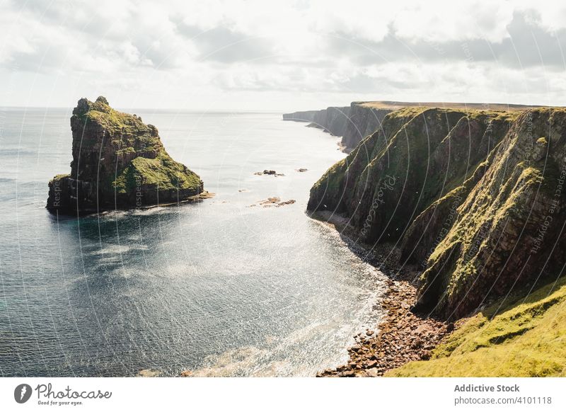 Rocky coast among tranquil ocean water in sunny day sea adventure height headland trip coastline cliff fresh freedom road solitude marine endless shore scotland