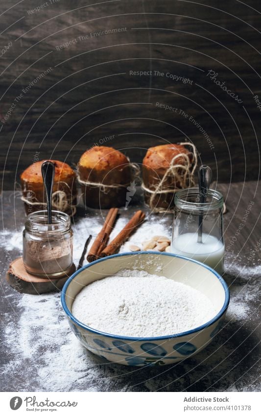 Christmas panettone and ingredients for recipe on wooden surface cake bake flour holiday christmas food bakery xmas bread dessert homemade prepare kitchen