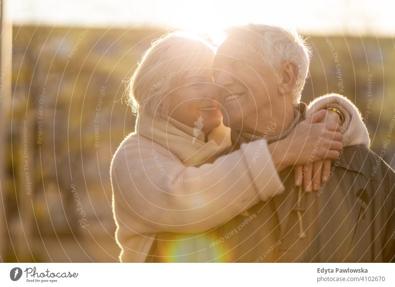 Senior couple hugging outdoors in autumn woman love people together two senior mature pensioners togetherness retiree retired retirement old marriage healthy