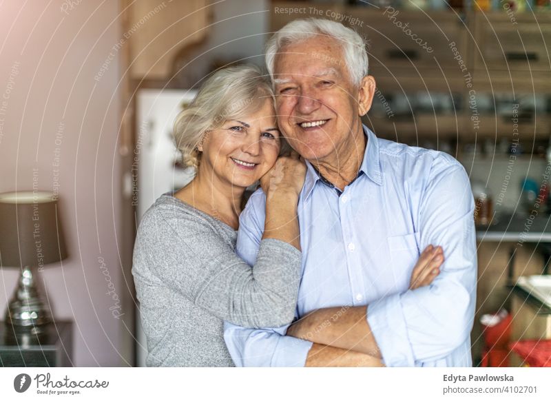 Happy senior couple embracing in their home woman love people together two mature pensioners togetherness retiree retired retirement old marriage healthy