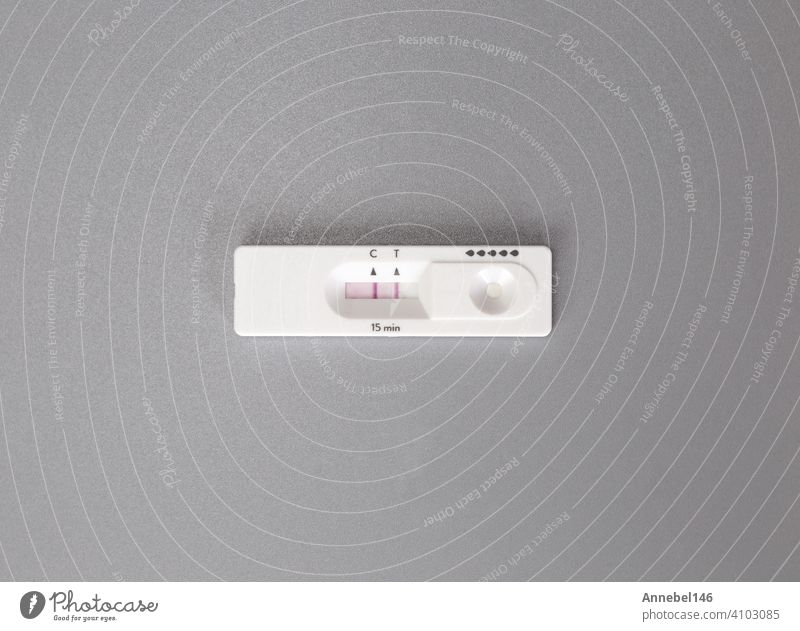 Positive result of coronavirus, covid-19 quick self test at home on gray background top view. Coronavirus,Health,industry concept with copy space positive