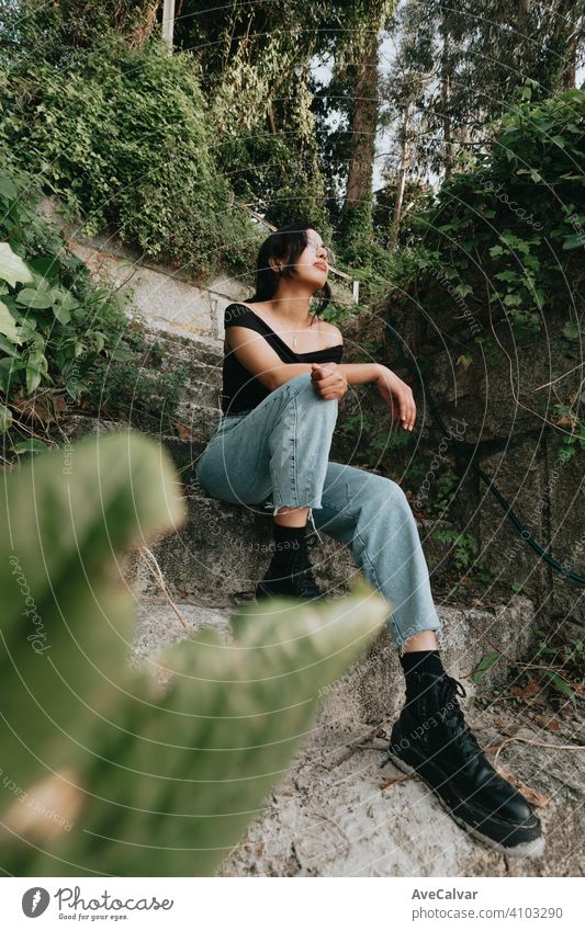 Young beautiful african woman sitting on some stairs on spring clothes and glasses american multicultural young ethnic hispanic latin model skin smile gypsy