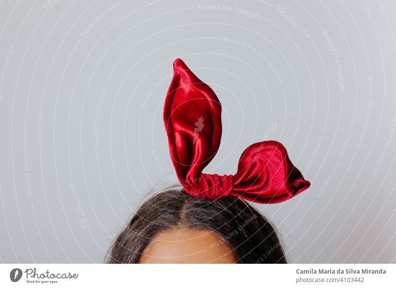 Young woman with black dress and red bow in her hair. Fashion photography. Autumn / winter fashion. Hair accessory. beautiful beauty blogger elegance face