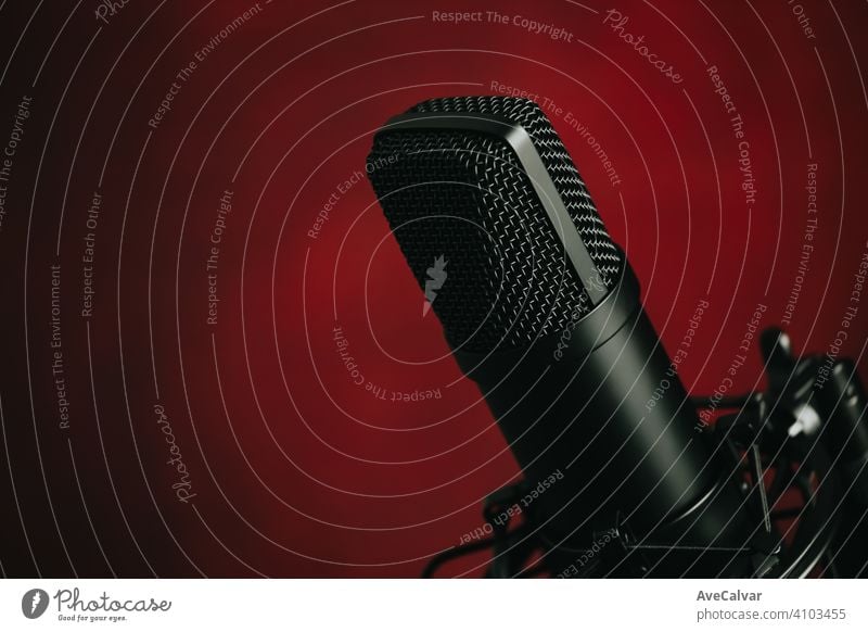 A close up of a streaming microphone over a red background with copy space record audio technology music professional sound radio recording studio apartment