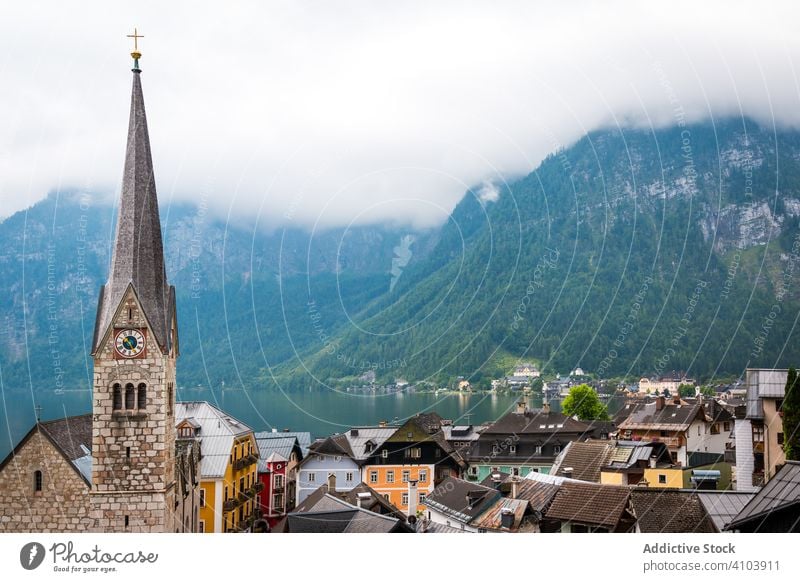 Calm lake and town near mountains calm shore cloudy daytime landscape water austria scenic house architecture exterior structure construction cottage coast