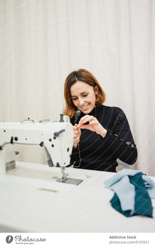 Seamstress using sewing machine in workshop seamstress woman fabric craft occupation material clothing female adult tailor part element detail professional