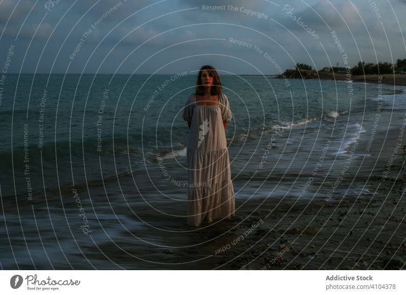 Female tourist seaside woman beach waves barefoot seashore sky heaven dusk clouds female lady walking coastline empty lonely blue dress beautiful vacation water