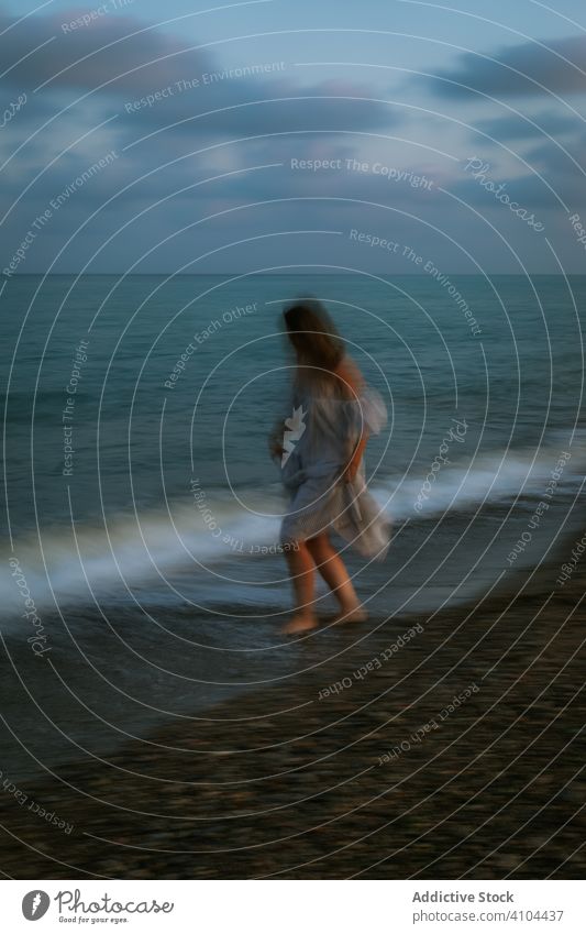 Female tourist seaside woman beach waves barefoot seashore sky heaven dusk clouds female lady walking coastline empty lonely blue dress beautiful vacation water