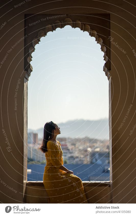 Female traveler in arch of old fortress woman building tourism shabby alcazaba malaga spain female trip journey visit destination architecture weathered brick