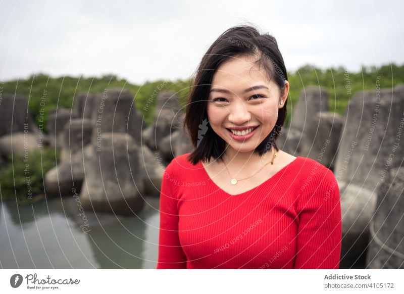 Satisfied Asian woman on vacation during excursion sightseeing tourism happy smile asian ethnic casual travel rock relaxation female summer beautiful taiwan