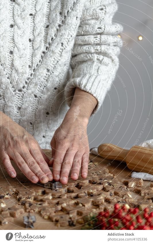 Anonymous lady preparing cookies with tin form for baking cooking using woman kitchen rolling pin dough process shape star festive pastry preparation food arms