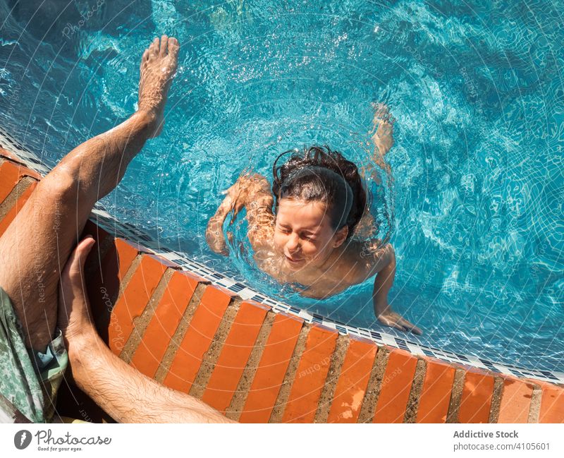 Father supervising daughter swimming in pool father lifeguard swimming pool resort water summer family together vacation child kid girl man holiday weekend wet