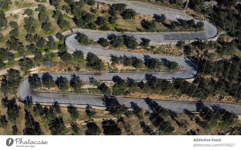 Aerial view of snake road aerial landscape travel beautiful green nature forest countryside drone scenic high mountain trees asphalt curvy curve hill scenery