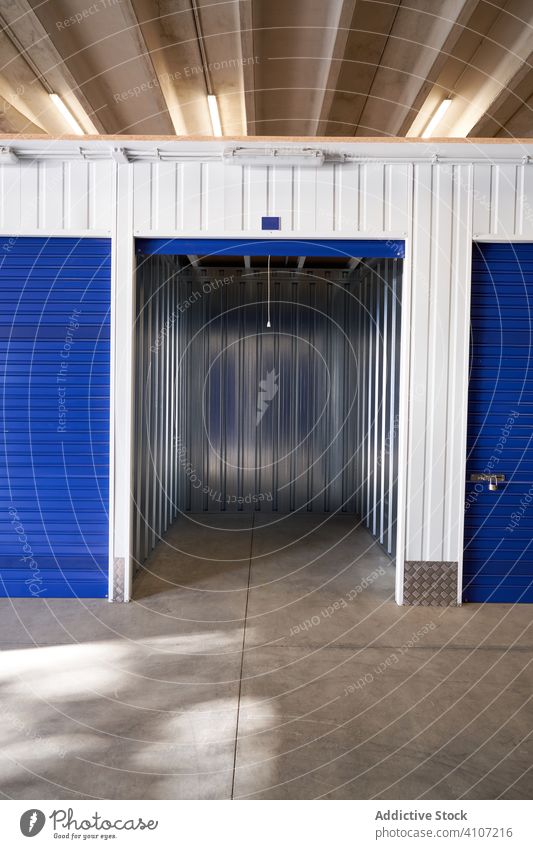 Self storage doors inside building padlock room metal safety security combination box closed row locker hallway compartment cubicle corridor indoor clean blue