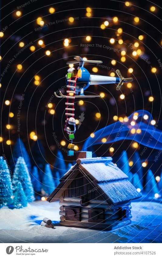 Funny Christmas scene from toys decoration santa claus house winter design season colorful celebration new year lights christmas ladder gift helicopter present