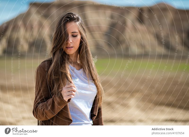 Female tourist enjoying trip in desert woman travel vacation casual stylish summer tourism blue sky nature lifestyle holiday young female landscape mountain