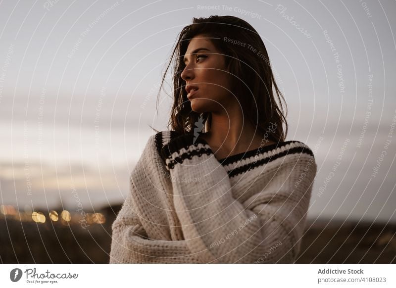 Sensual young woman in rural landscape sensual seductive sweater nude countryside wear twilight feminine sensitive female tender romantic attractive model