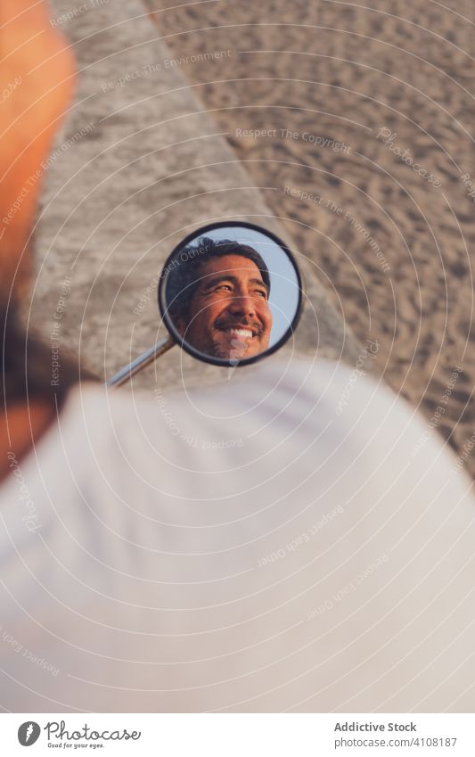 Happy man riding bike on beach sand happy mirror reflection enjoy summer cheerful positive adventure travel modern male journey trip nature vacation ride