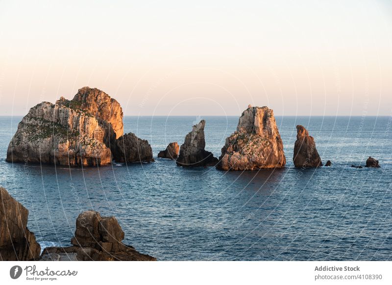 Peaceful landscape of rocky cove in sunset scenery peaceful sea skyline twilight coastline nature water destination tourism seascape cliff stone holiday summer