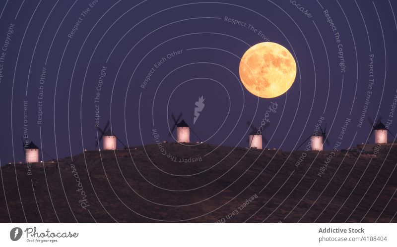 Scenic landscape of moon in countryside in twilight scenery valley windmill sundown sky nature dusk sunset tranquil calm peaceful environment dramatic