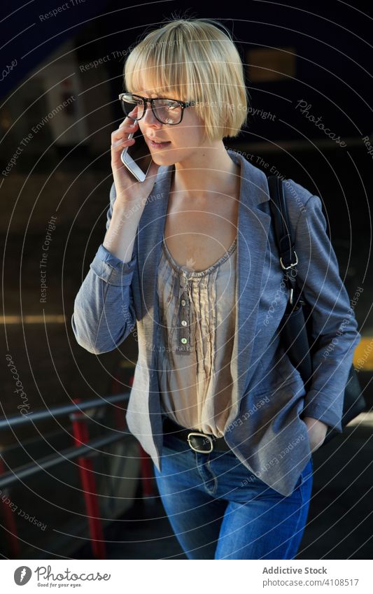 Blonde businesswoman talking on smartphone stylish young notepad mobile connection communication conversation female professional person beautiful attractive