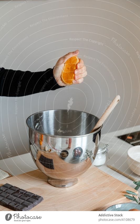 Woman squeezing orange over bowl squeeze prepare recipe ingredient kitchen hand food cook home homemade fresh juice cuisine dish culinary person housewife