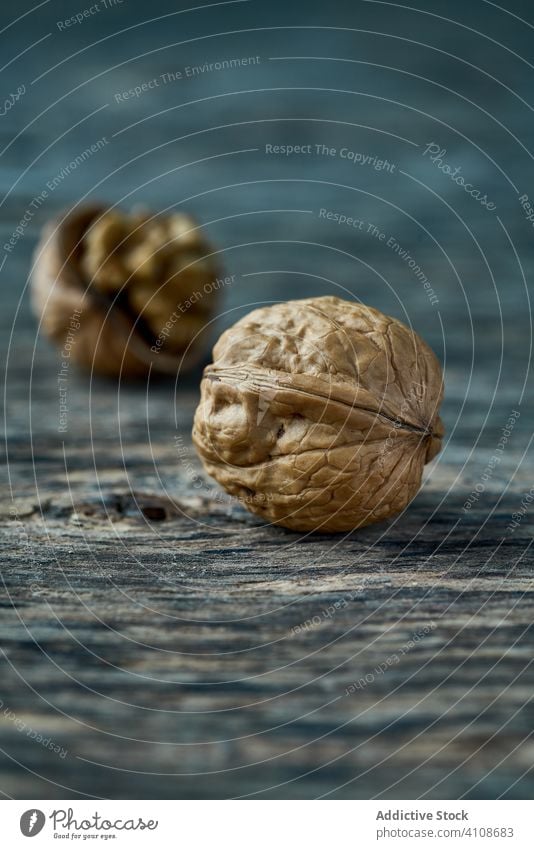 Unpeeled walnut on the table unpeeled healthy edible wooden filbert harvest gathering heap ingredient natural organic raw cracked seed food snack tasty seasonal