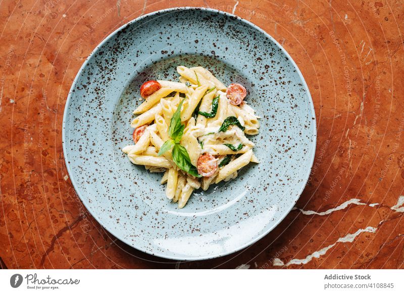 Fresh pasta with vegetables and sauce dish cherry tomatoes greenery haute cuisine restaurant plate italian basil bowl herb culinary organic classic tasty meal