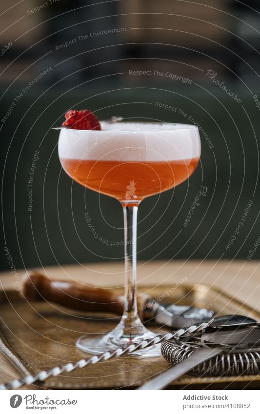 Clover Club cocktail in restaurant bar spoon strainer modern glass alcohol style clover club beverage drink gin raspberry foam red colorful decoration table