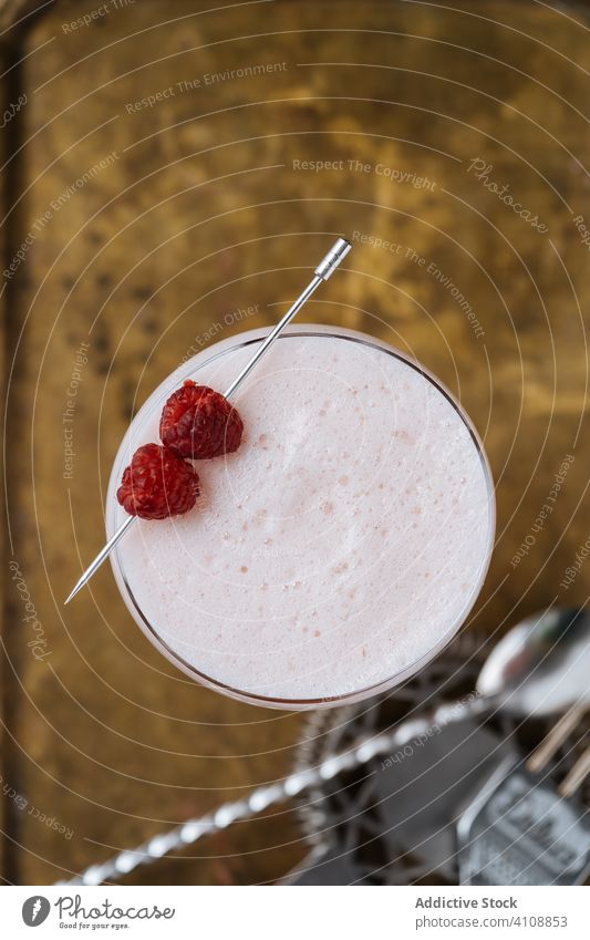 Clover Club cocktail in restaurant bar spoon strainer modern glass alcohol style clover club beverage drink gin raspberry foam red colorful decoration table