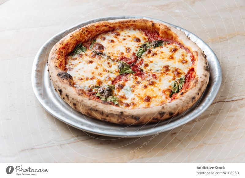 Fresh pizza with cheese in restaurant dish food meal tasty tradition italian lunch delicious cuisine round yummy fresh herb plate portion crust appetizing