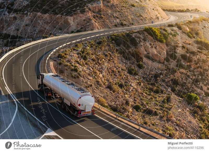 Fuel tanker driving on a mountain road by the sea. Camion cisterna mercancias peligrosas suministro combustible Dangerous Montaña Curvas Adr Inflamable