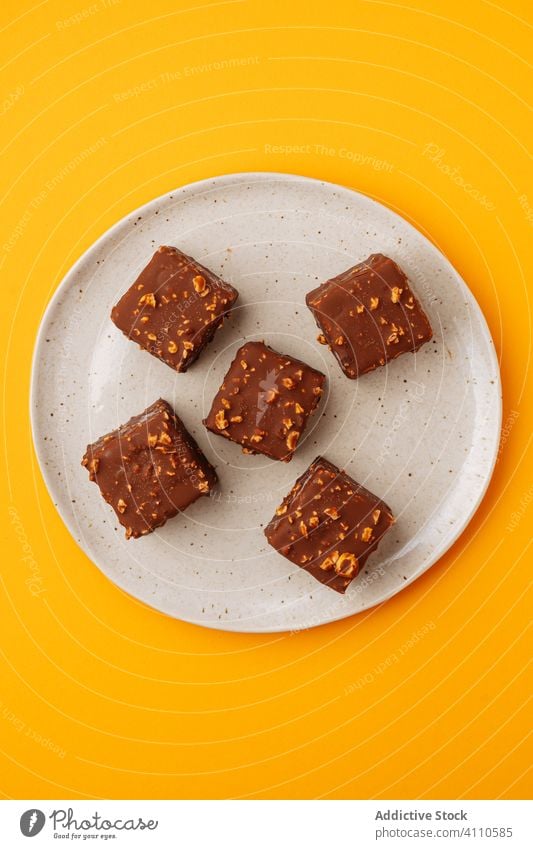 Cookies with chocolate and nut icing dessert cookie plate cube sweet food pastry tasty cuisine dish delicious yummy scrumptious sugar calorie portion piece